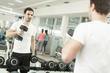Fototapeta na wymiar Young man training in the gym
