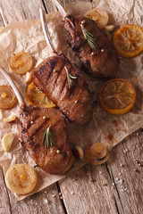 Rustic beef steak with lemon on the table close-up. vertical top view
