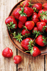 strawberries in an old clay bowl
