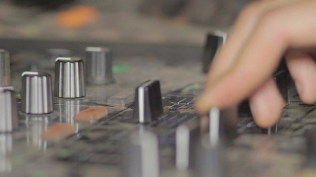 Fingers of a Disk Jockey touching Consolle at the Night Party