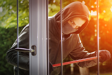Burglar breaking in a house