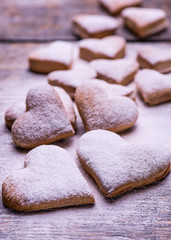 Cookies and biscuits in the shape of a heart for Valentine's day on a wooden background.