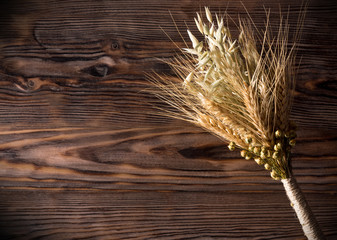 sheaf of ears on the wooden background