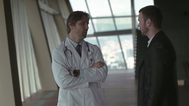 doctor with a patient family at bright modern office in hospital