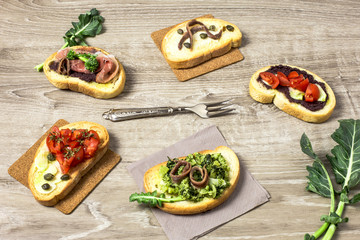 various bruschettas over wooden table
