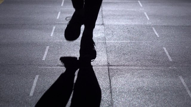 Person jumps on the jumping rope, feet in silhouette, front view