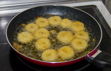 Breaded slices of banana in frying pan