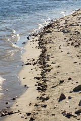 sand and water on the shore of a lake