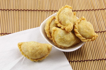 Curry puff on bamboo mat