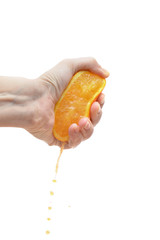 Female hand squeezing an orange on white background