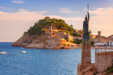 Statue of Minerva on the enbankment, Fortress and Badia de Tossa bay in Tossa de Mar on Costa Brava...