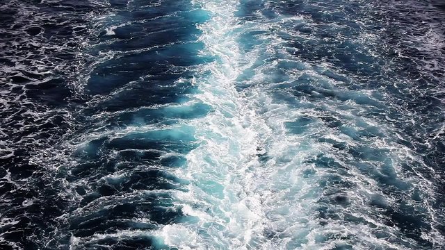 Seawater with sea foam behind a boat as background, full HD video
