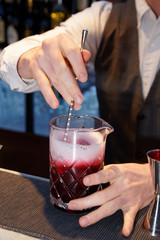 Bartender is stirring a shrub cocktail