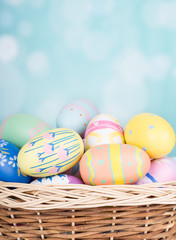 Fototapeta na wymiar Basket of Easter Eggs on a Bright Background