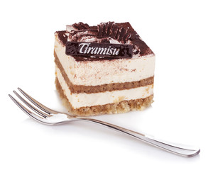 Tiramisu dessert with fork close-up on a white background.