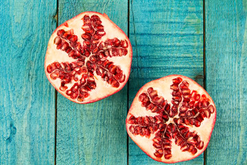 Ripe pomegranate fruit on wooden vintage background. Healthy vegetarian food. Recipe, menu, mock up, cooking.