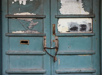 Chain lock on grungy abandoned building doors