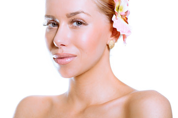 Fototapeta premium Beauty face of the young beautiful woman with flower