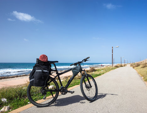Bicycle is on road near sea