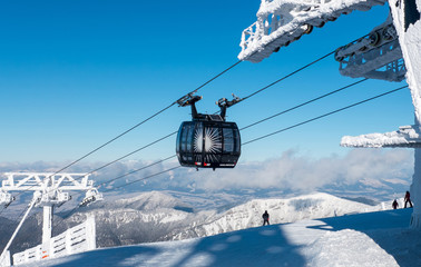 Cable car in Low Tatras mountains, Slovakia, winter ski resort with snowy peaks, travel destination and alpine landscape in clear weather