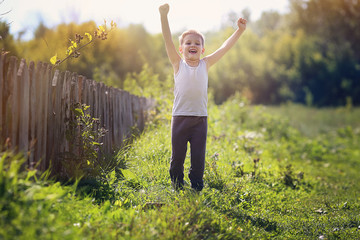 The boy, a child walks in the garden.