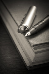 pen and book with filter effect retro vintage style