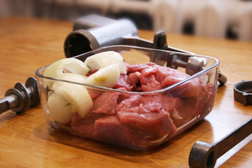 Fresh meat with onions become meat grinder.