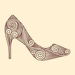 Brown ornamental shoe on light beige background