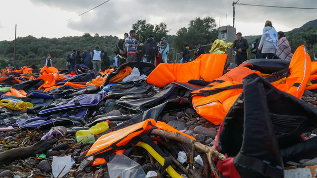 Abandoned belongings and life jackets on the Lesvos shore