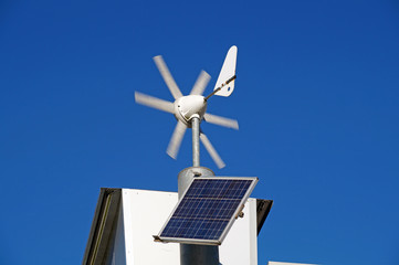 Solar panel with domestic wind turbine