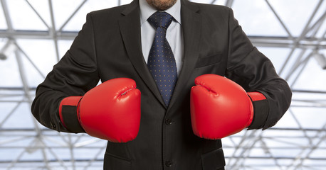 Businessman in red boxing gloves
