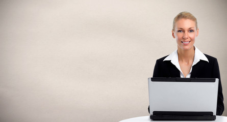 Young business woman working with laptop.