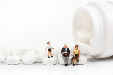 miniature people  - Elderly people posing in front of pills