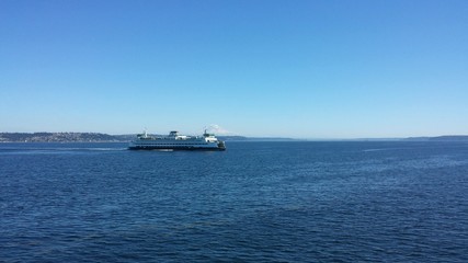 Ferry with mountain backdrop.