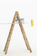 painter wooden ladder with roller paint and paint
