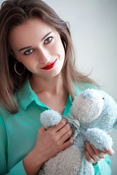 Girl in the turquoise shirt with a blue teddybear