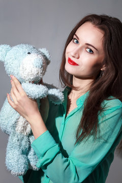 Girl in the turquoise shirt with a blue teddybear