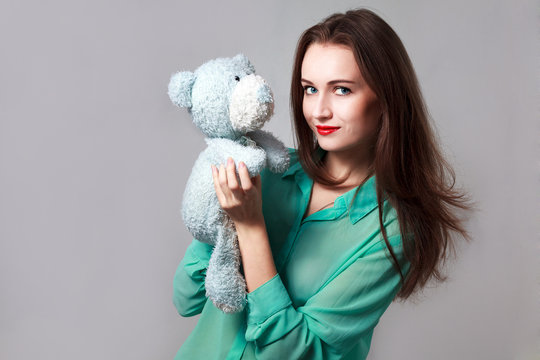 Girl in the turquoise shirt with a blue teddybear