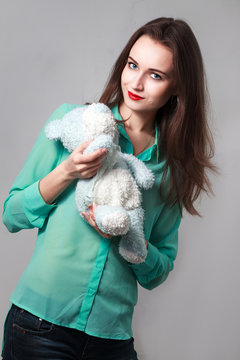 Girl in the turquoise shirt with a blue teddybear