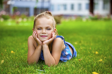 Little happy girl in summer park