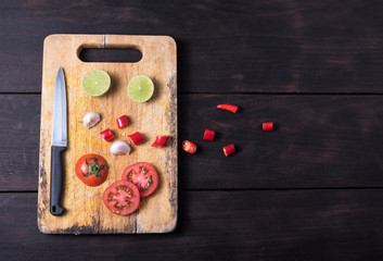 ingredients and knife on dark background