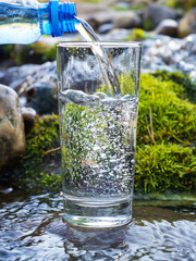 Water pouring into a glass from bottle
