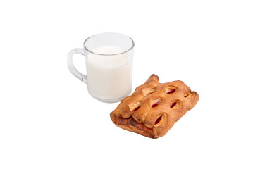glass mug with milk and a bun with jam
