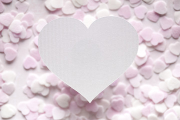 White paper heart and many small hearts in background