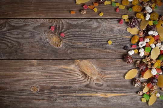 nuts and dried fruits mix on wooden background