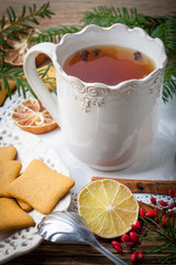 Winter hot drink with spices on wooden table.
