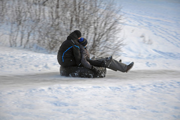 Fototapeta na wymiar Skating with ice slides on a car tire