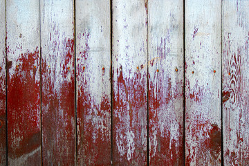 Weathered wood planks half painted in red and white color