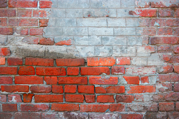 Red brick wall with part coverd with plaster