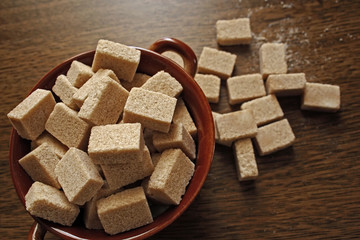 A bowl full of brown sugar cubes